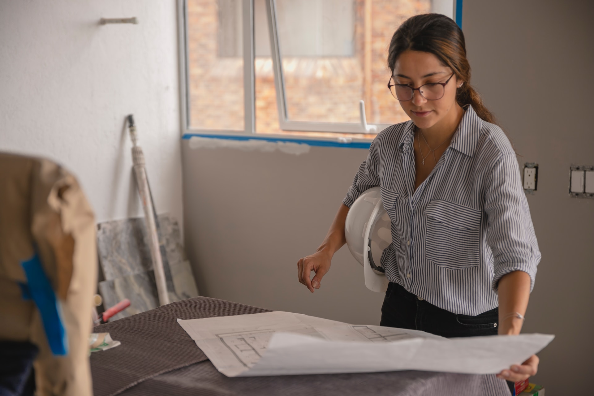 woman working on construction plan